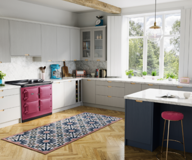 AGA ER7i kitchen roomset. The ER7i is pictured in raspberry, flush to white counters in a warm and bright kitchen.