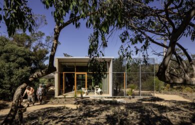 Street-facing elevation framed by eucalypts; garden contours slow stormwater to nourish new plantings, photographed for green magazine issue 105: Timeless by Trevor Mein.