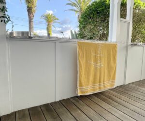 Low positioned curved brackets on a verandah as a folding clothesline