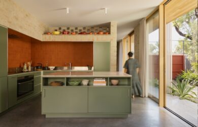 Central kitchen with display shelving for colourful pots and Bennett’s Pottery tiles, photographed for green magazine issue 106: Playful Echoes by Timothy Kaye.