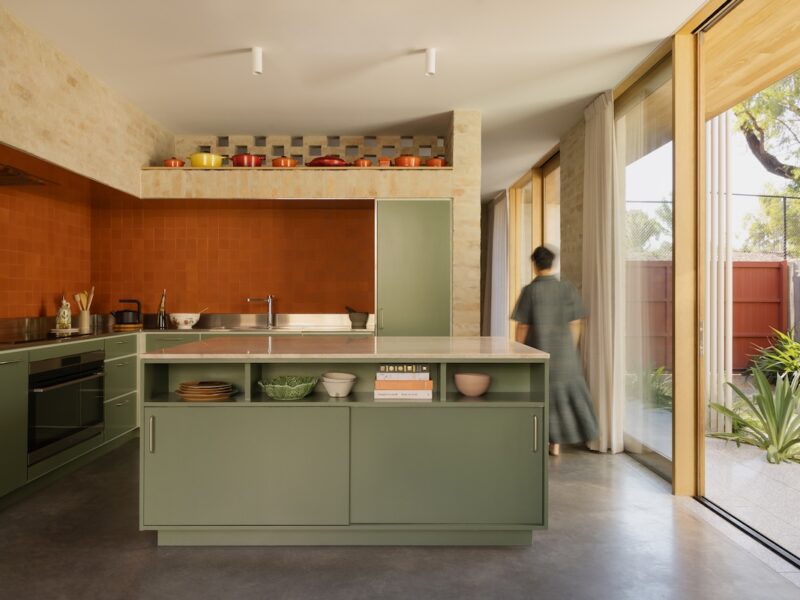 Central kitchen with display shelving for colourful pots and Bennett’s Pottery tiles, photographed for green magazine issue 106: Playful Echoes by Timothy Kaye.