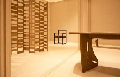 Detail view of the timber screen and seating within the Re-editions pavilion, highlighting American red oak construction and the geometric grid layout.