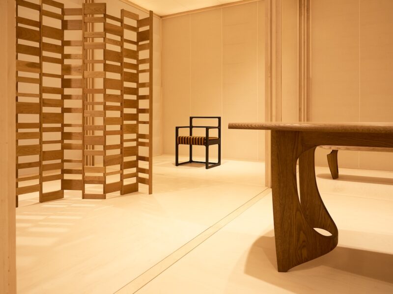 Detail view of the timber screen and seating within the Re-editions pavilion, highlighting American red oak construction and the geometric grid layout.