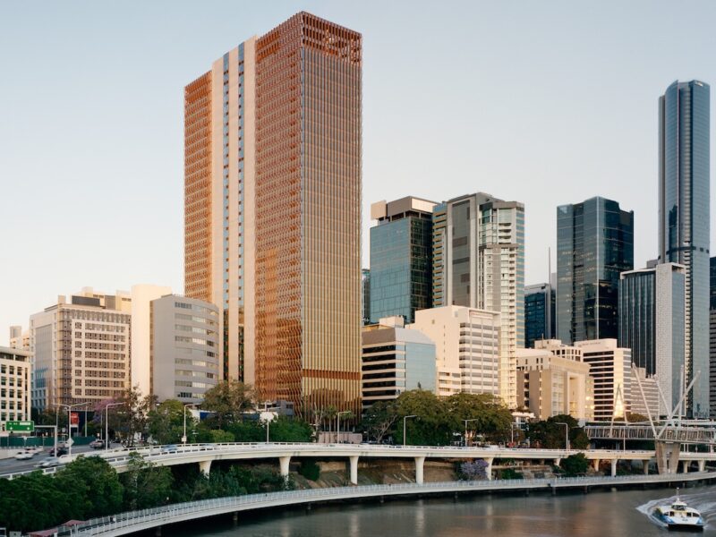 Wide view of the 205 North Quay tower within the Brisbane city skyline beside the river, surrounded by neighbouring commercial buildings.
