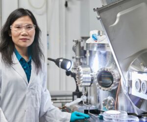 Scientia Professor Xiaojing Hao working in a UNSW laboratory alongside photovoltaic research equipment used in solar cell development.