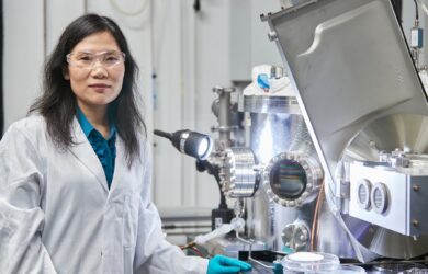 Scientia Professor Xiaojing Hao working in a UNSW laboratory alongside photovoltaic research equipment used in solar cell development.