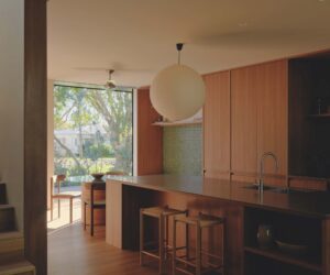 Sitting on a raised podium, the kitchen defines its own zone, flows seamlessly to the surrounding interiors and maintains a quiet dialogue with the streetscape, photographed for issue 107: A Coastal Compact by Tom Ross.