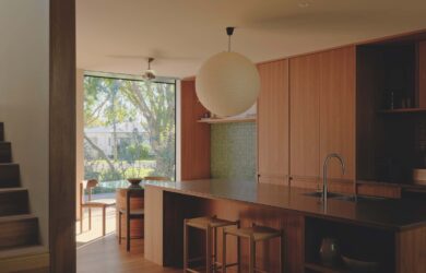 Sitting on a raised podium, the kitchen defines its own zone, flows seamlessly to the surrounding interiors and maintains a quiet dialogue with the streetscape, photographed for issue 107: A Coastal Compact by Tom Ross.
