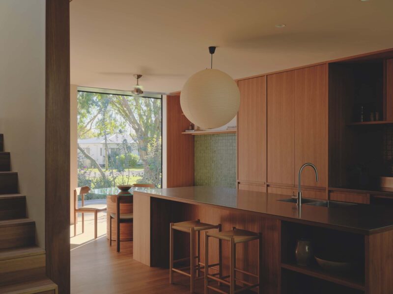 Sitting on a raised podium, the kitchen defines its own zone, flows seamlessly to the surrounding interiors and maintains a quiet dialogue with the streetscape, photographed for issue 107: A Coastal Compact by Tom Ross.