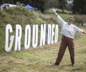 GROUNDED 2025 - Tracey at GROUNDED sign